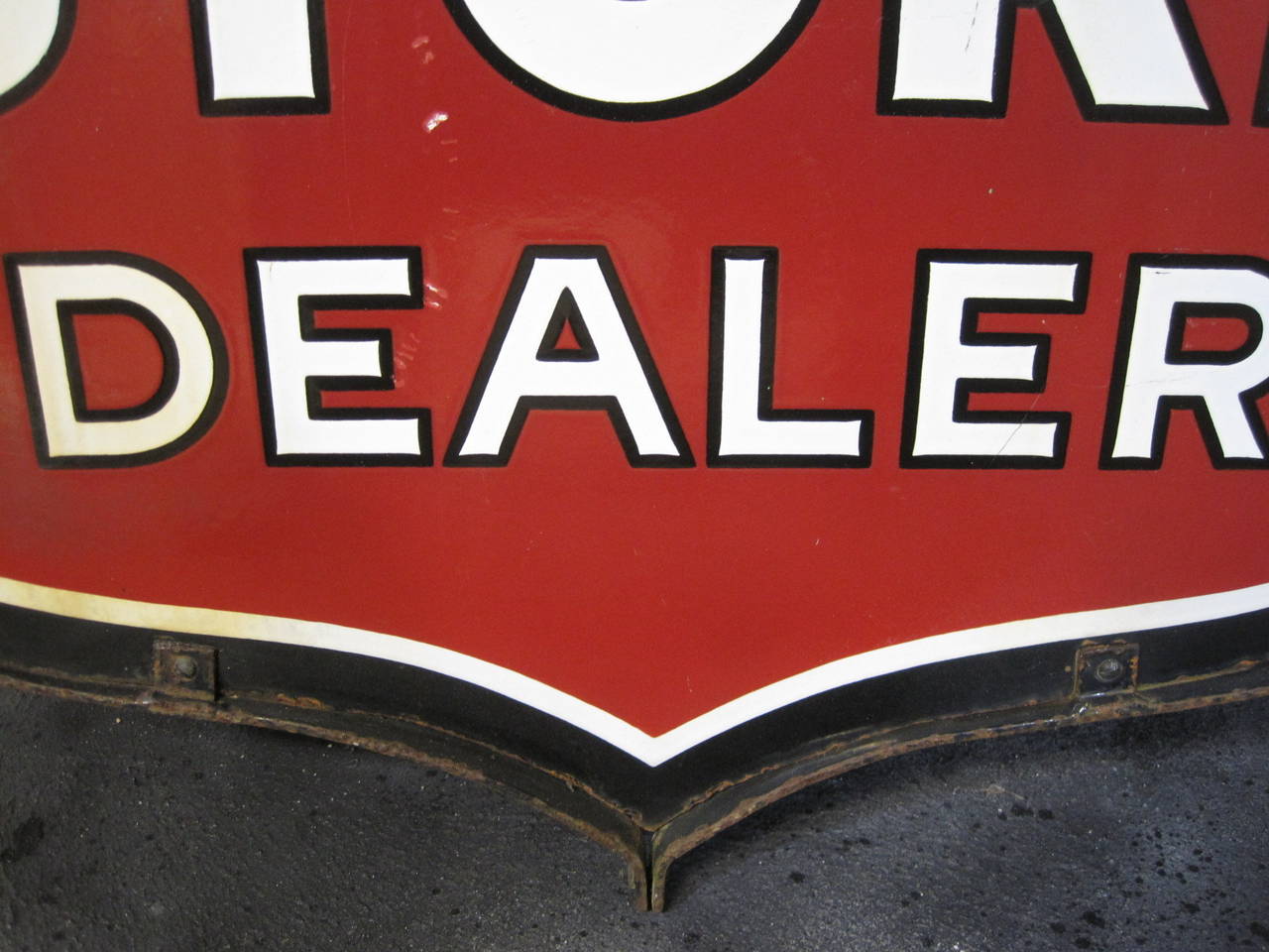 Double-sided sign with wrought iron frame. In good condition for a porcelain sign of this age.


