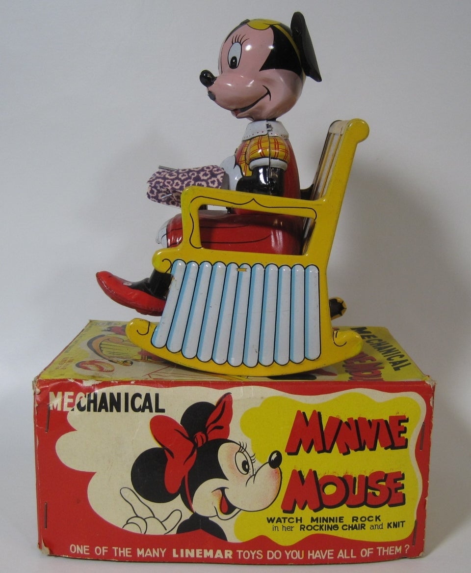 Linemar Tin wind-up Minnie Mouse toy with original box.
Seated in her yellow and blue rocking chair, Minnie swings back and fourth when wound, all the while appearing to be knitting. Very good working condition.

Free shipping within the United