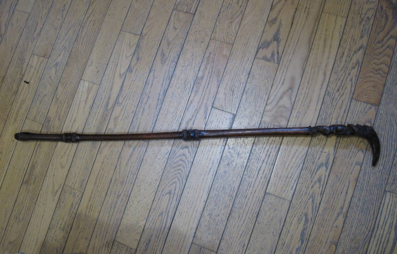 Maori Tribal "Chief's" staff or walking stick. This very finely carved staff or walking stick has an excellent deep reddish-brown patina. The top section is dominated by a finely-rendered ancestor figure. The figure has extensive facial