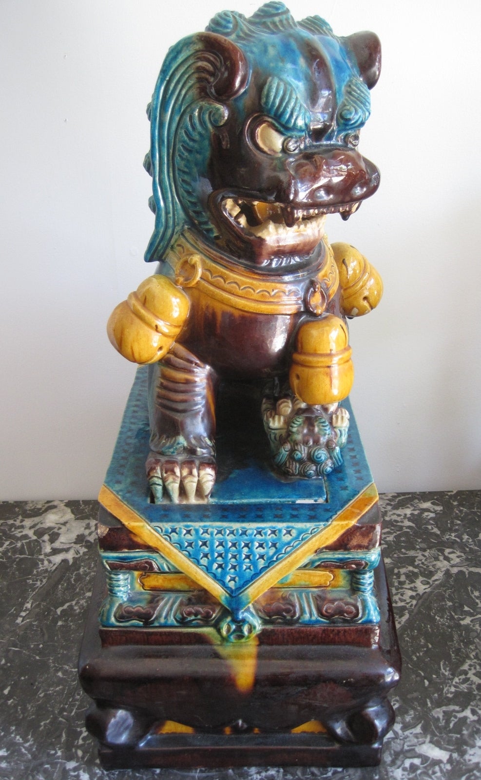 19th Century Chinese Porcelain Foo Dog on Pedestal

Statues of guardian lions have traditionally stood in front of Chinese Imperial palaces, Imperial tombs, government offices, temples, and the homes of government officials and the wealthy, from