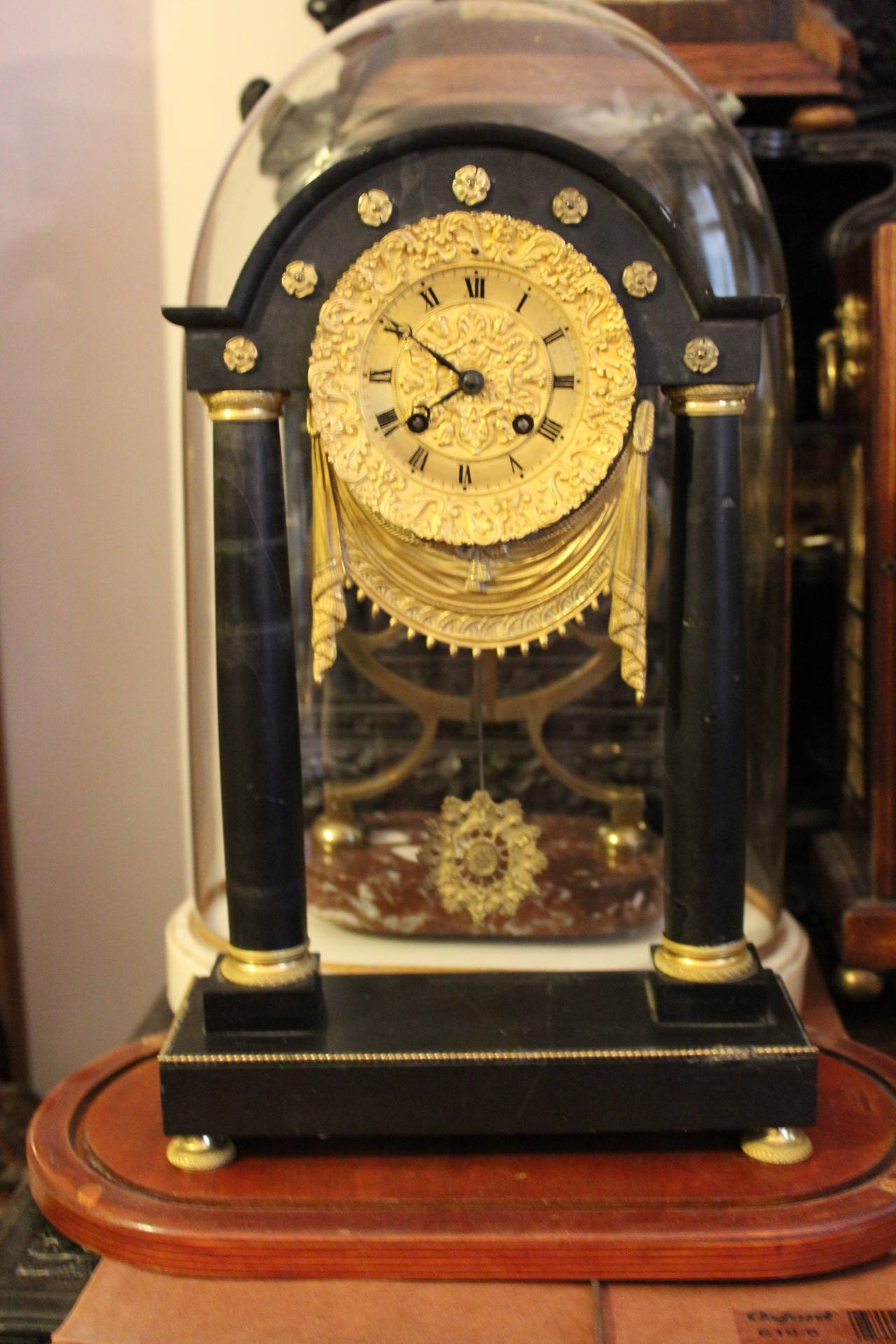 Early 19th century French Empire period portico clock.

French Empire black marble portico clock with decorative ormolu mounts.

Free shipping within the United States and Canada.