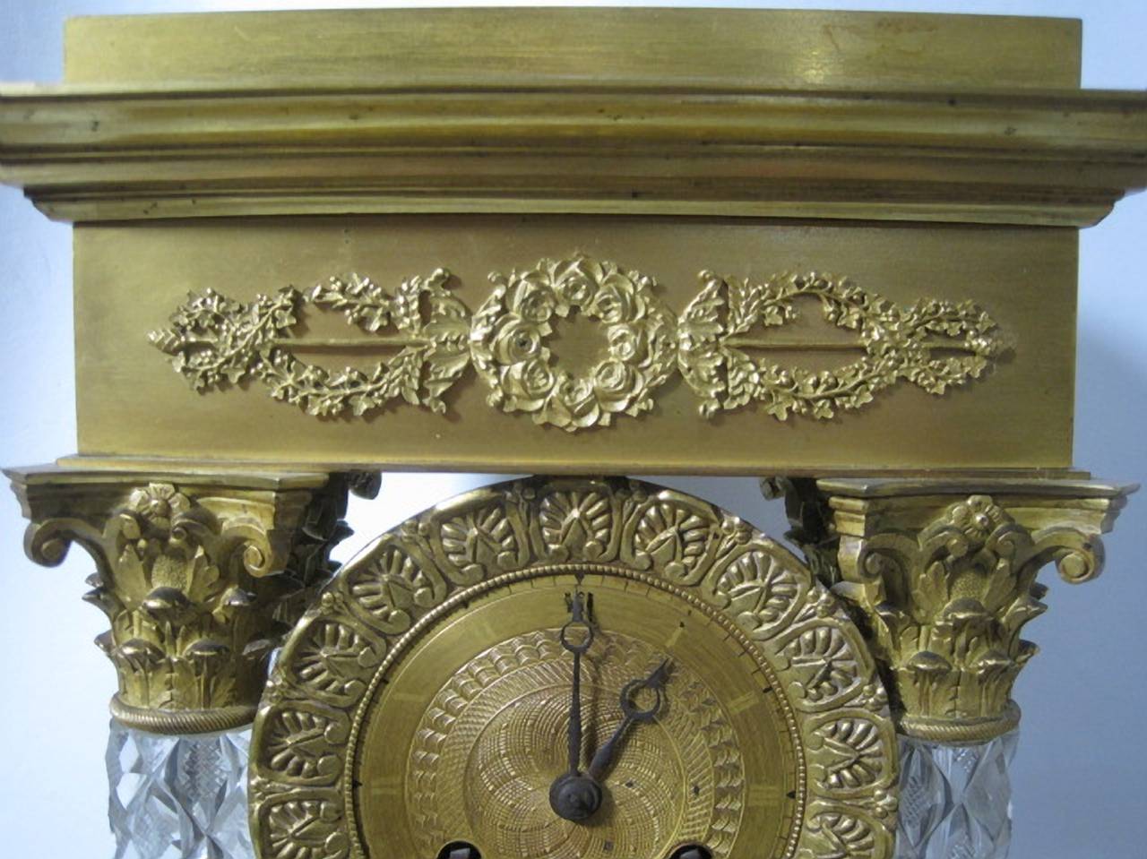 French Empire clock garniture with gilt bronze and Baccarat crystal.

An important French Baccarat cut-crystal and ormolu mantel clock with four Corinthian style columns. The cut-crystal features a cross hatched diamond patterns throughout. The