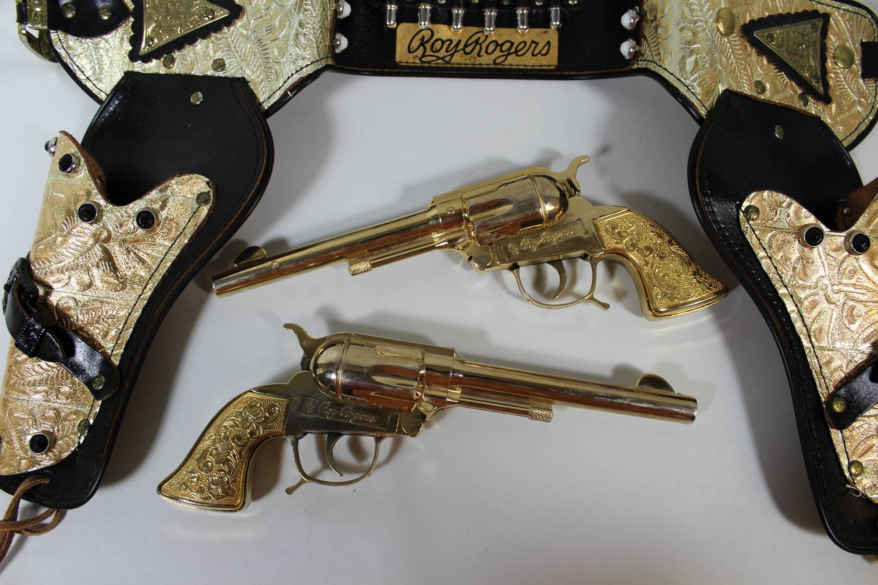 Rare Official Roy Rogers Boxed Holster Set With Letter Signed by Roy Rogers

Extremely rare, one of a kind Roy Rogers fourteen carat gold and black jeweled  toy holster and gun set.  This was given away in 1957 as third place prize in the Roy