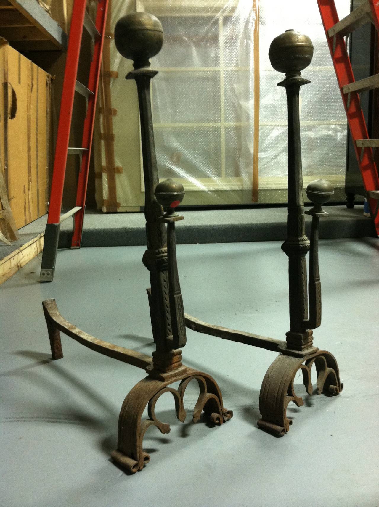 Continental Europe, probably France, circa 1740.

The towering wrought iron posts with spit brackets, each with brass ball finials on arched and arcaded bracket feet.