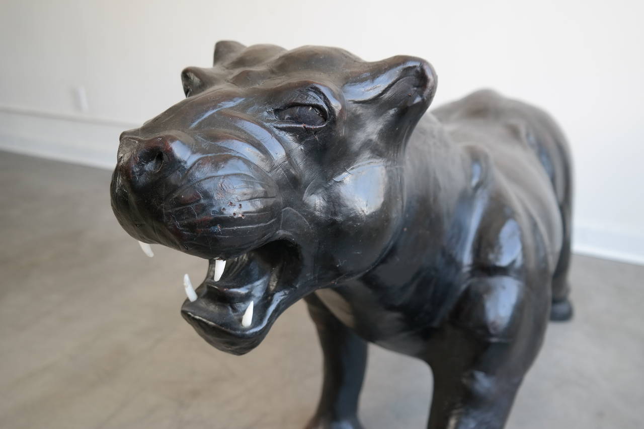 Beautiful lifesize sculpture of a black panther in leather with great age and patina. Very detailed sculpture shows excellent form of the panther, manufacture and creator is unknown at this time.