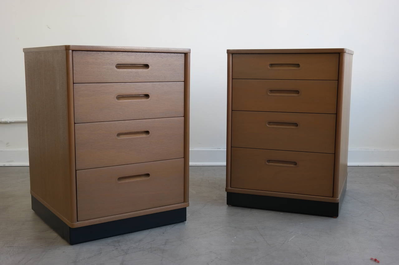 Wonderful pair of nightstands designed by Edward Wormley for Dunbar. In excellent restored condition featuring four large drawers for storage, bases were wrapped in black vinyl. They retain the original Dunbar label, circa 1960s, USA.
