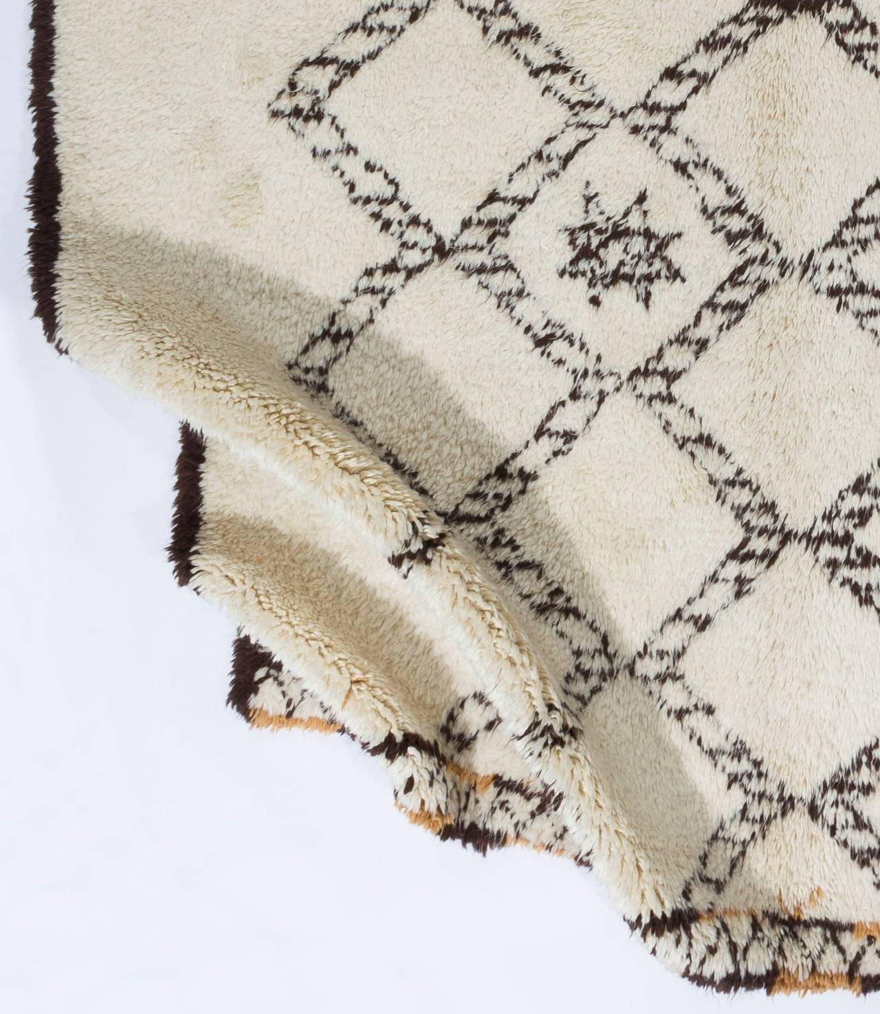 A contemporary hand-knotted Moroccan rug, made of un-dyed sheep's wool in brown and ivory. It has soft, lustrous wool pile that is ideal for families with kids and those who seek coziness and comfort with a modern, minimalist aesthetic.  The rug