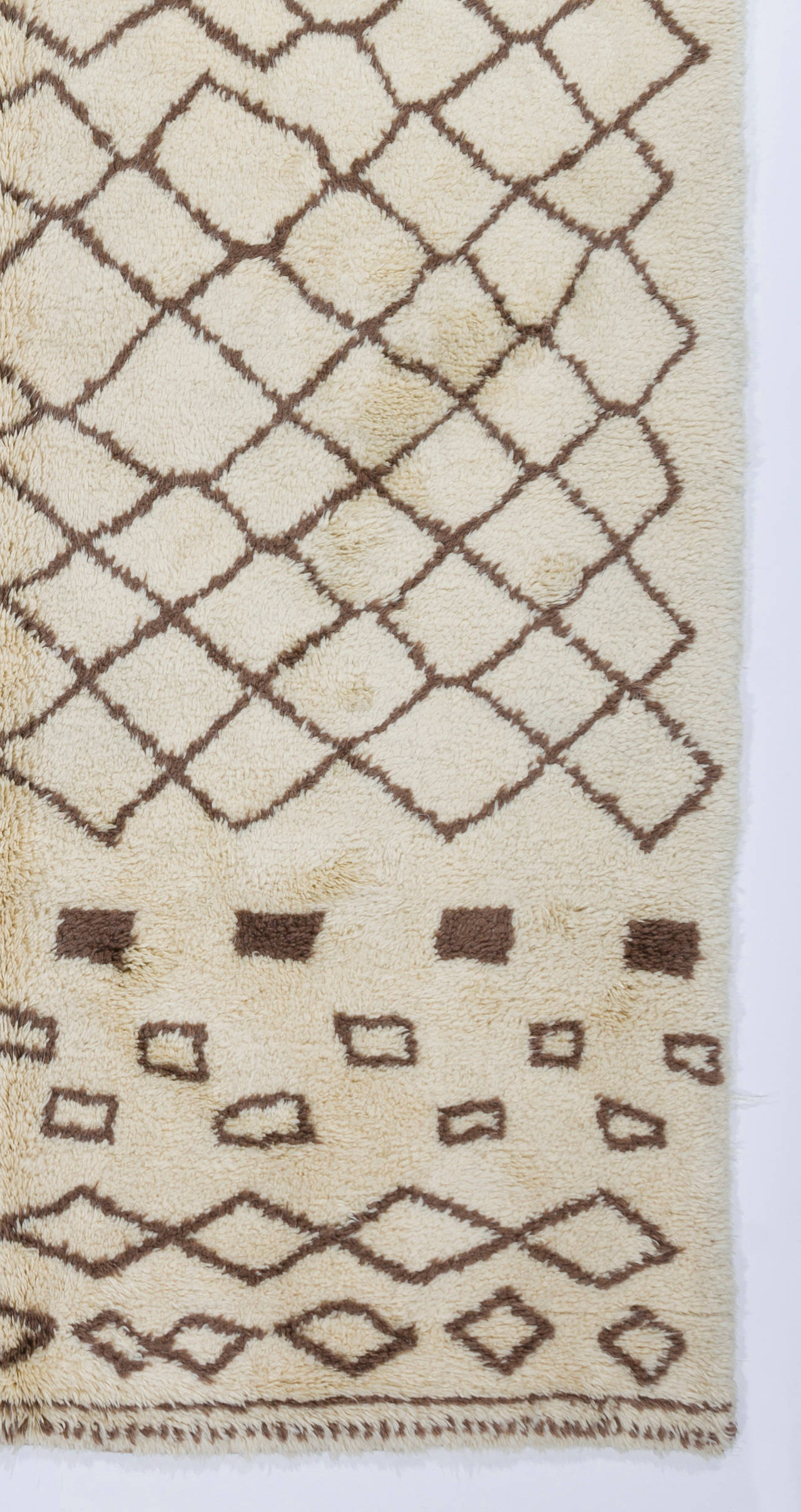 A new handmade rug made of natural hand-spun undyed cream and brown sheep wool. 

The rug can be custom-produced in any size, color, pattern, weave and design in approximately 5 weeks. You choose, we deliver.