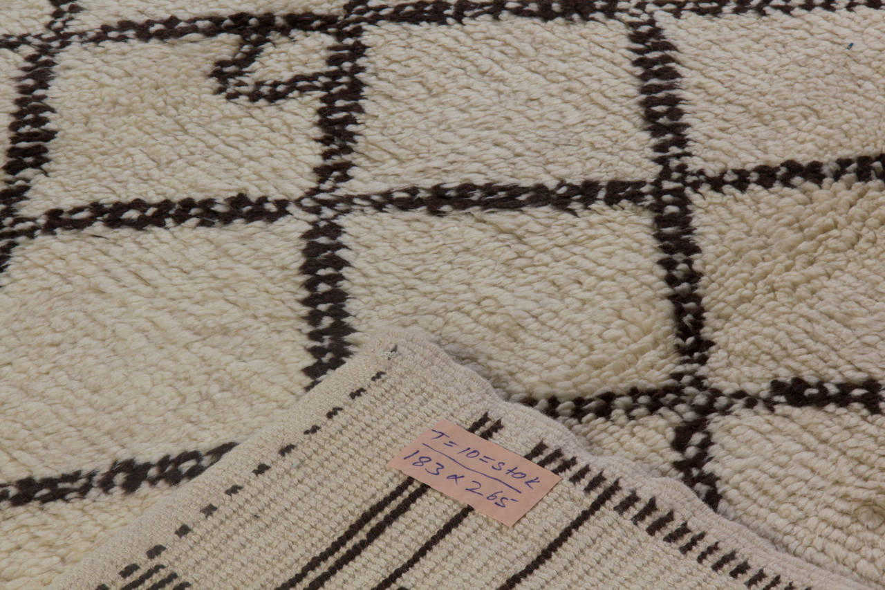 A new handmade rug made of natural un-dyed ivory/cream and dark brown sheep wool.
The design is inspired from vintage Moroccan rugs.
The rug is available as seen or if requested, it can be custom produced in a different size, color combination and