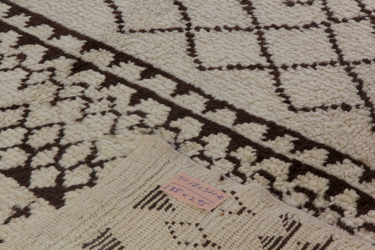 A modern handmade rug made of natural undyed ivory and brown sheep wool. The design is inspired from vintage Moroccan rugs. 
The rug is available as seen or it can be custom produced in a different size, color combination and design if requested.