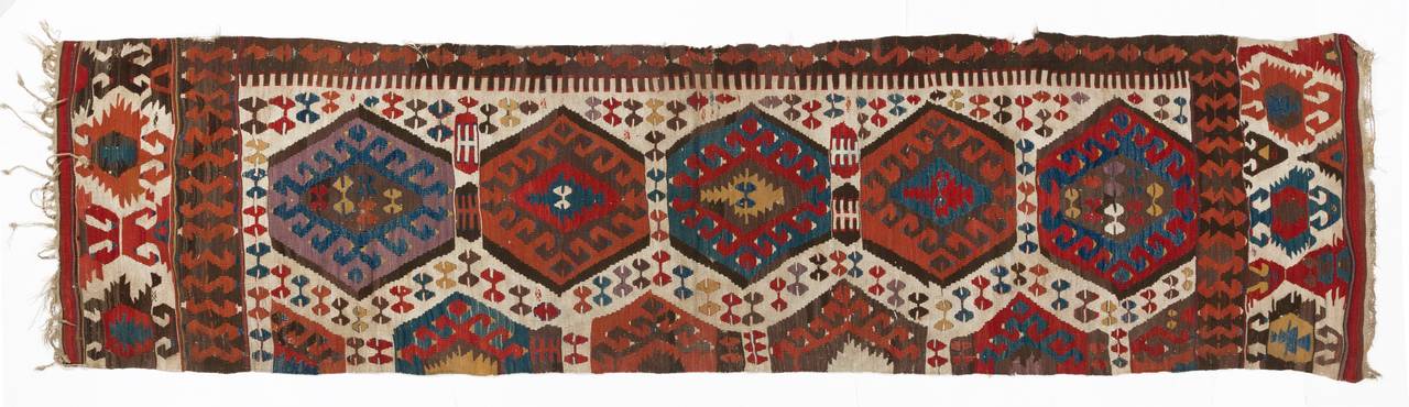 An antique flat-woven wool rug from Konya region in central Turkey. This weaving can be used in various ways such as a wall hanging, seating cover or runner.