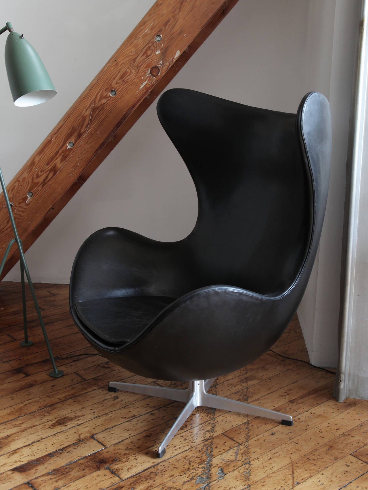 Original Egg in black leather with fluted base, designed by Arne Jacobsen in 1958 for the Radisson SAS hotel in Copenhagen, Denmark. Jacobsen, a Danish architect and designer, was inspired as a student in the 1920s by Le Corbusier, Mies van der