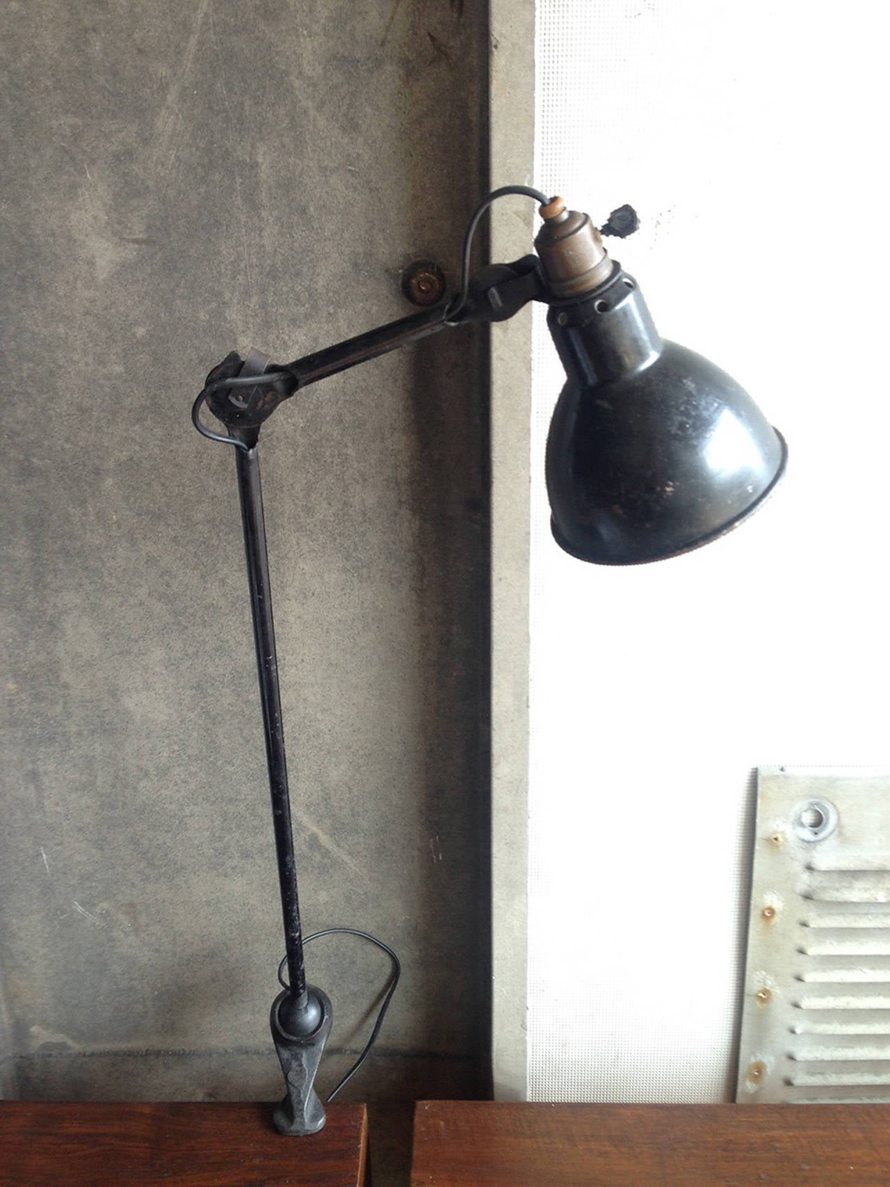 Original,1921 adjustable Lampe Gras Model 201. Cast steel with pivoting ball joint and table-top clamp. Bernard-Albin Gras, born in France in 1886, was an engineer dedicated to improving working conditions of mass labourers. An admirer of the lamp's