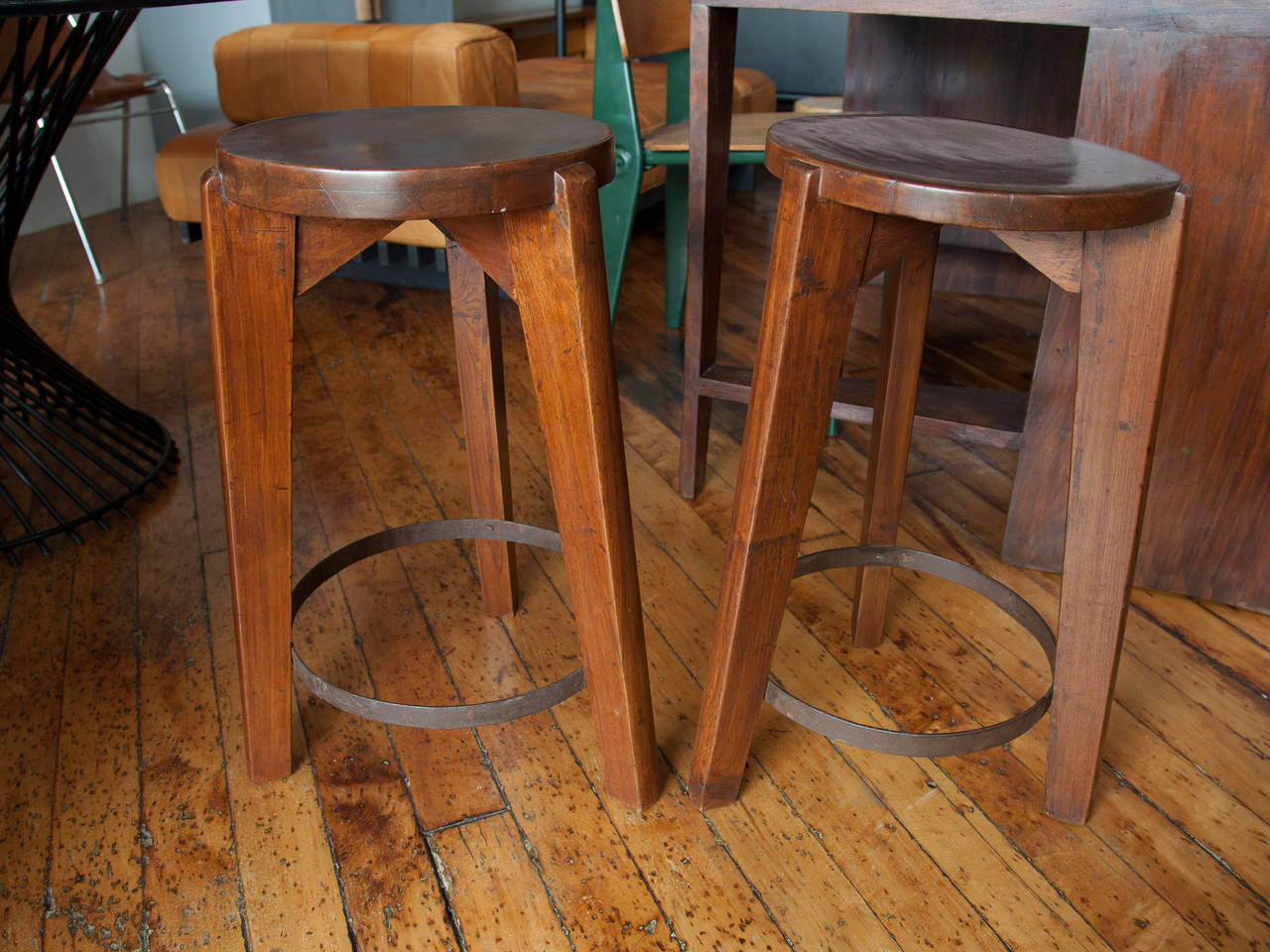 Stools with slightly concave, round seat and tapered legs in teak, by Pierre Jeanneret. From Punjab University in Chandigarh, India.