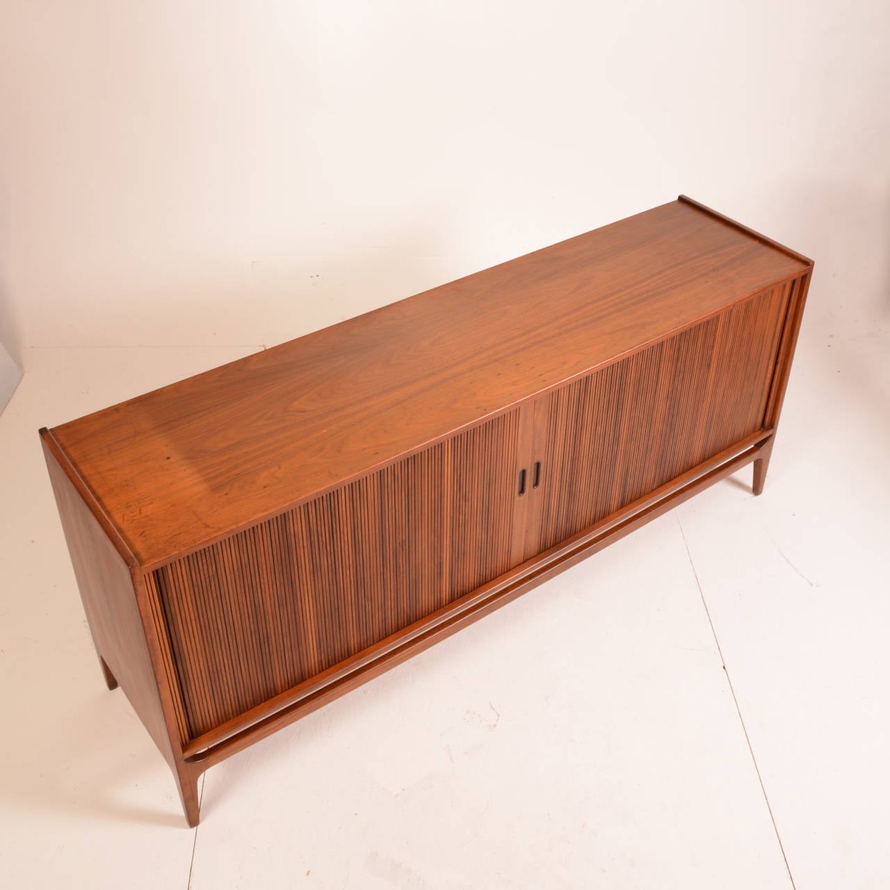 Tambour doored walnut credenza designed by Richard Thompson for Glenn of California. This is a great piece of California Modern. Made from beautifully selected walnut. Comes with the original drawer not pictured in the profile photos but shown in