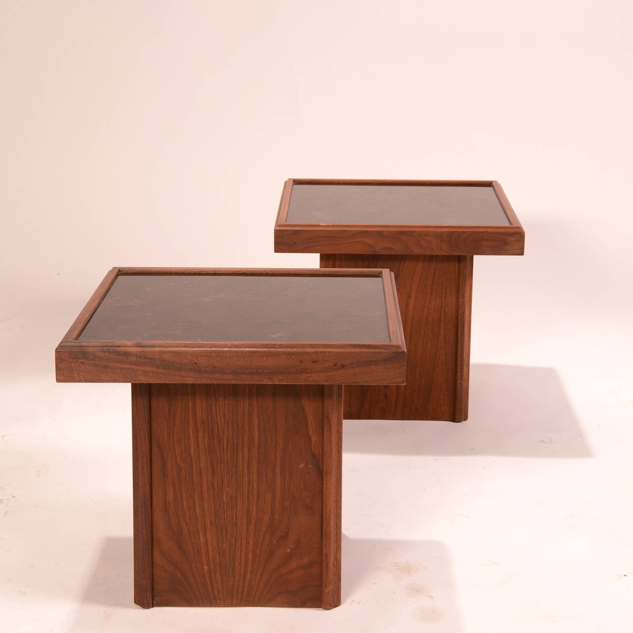 A pair of square walnut tables with a tile top on a square pedestal base, by John Keal for Brown Saltman. American, circa 1950.