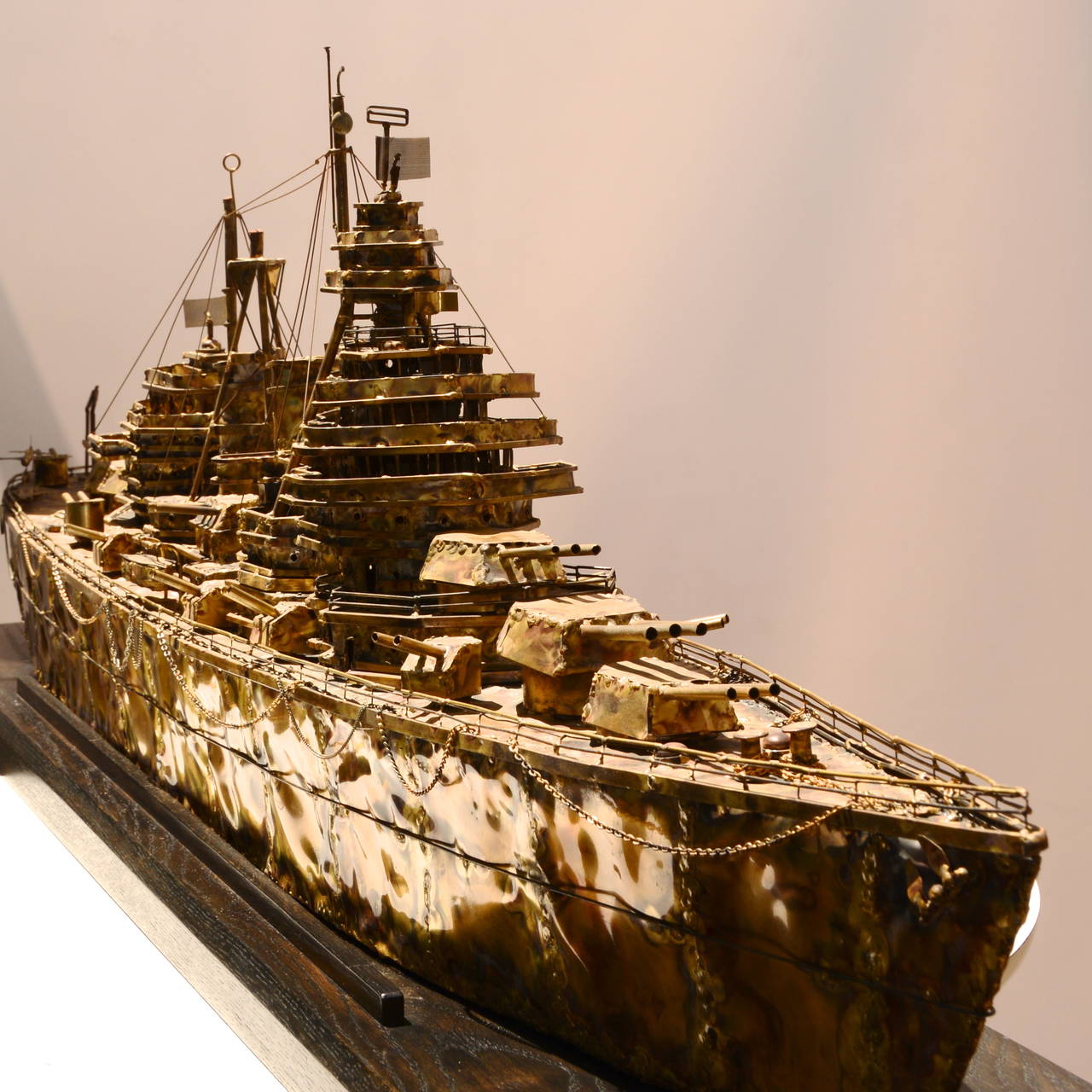 This is an amazing brass and steel battleship sculpture by Joe Venturini (1954).  This piece is considered one of his master works.