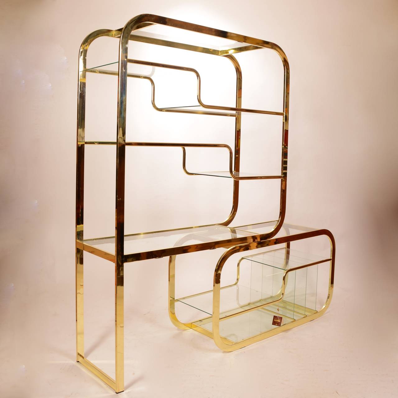 Brass and glass Etagere by Milo Baughman for Morex of Italy. This unit features a cantilever base that can moved to widen the design or make it more compact. Retains the original Morex of Italy sticker and tag.
