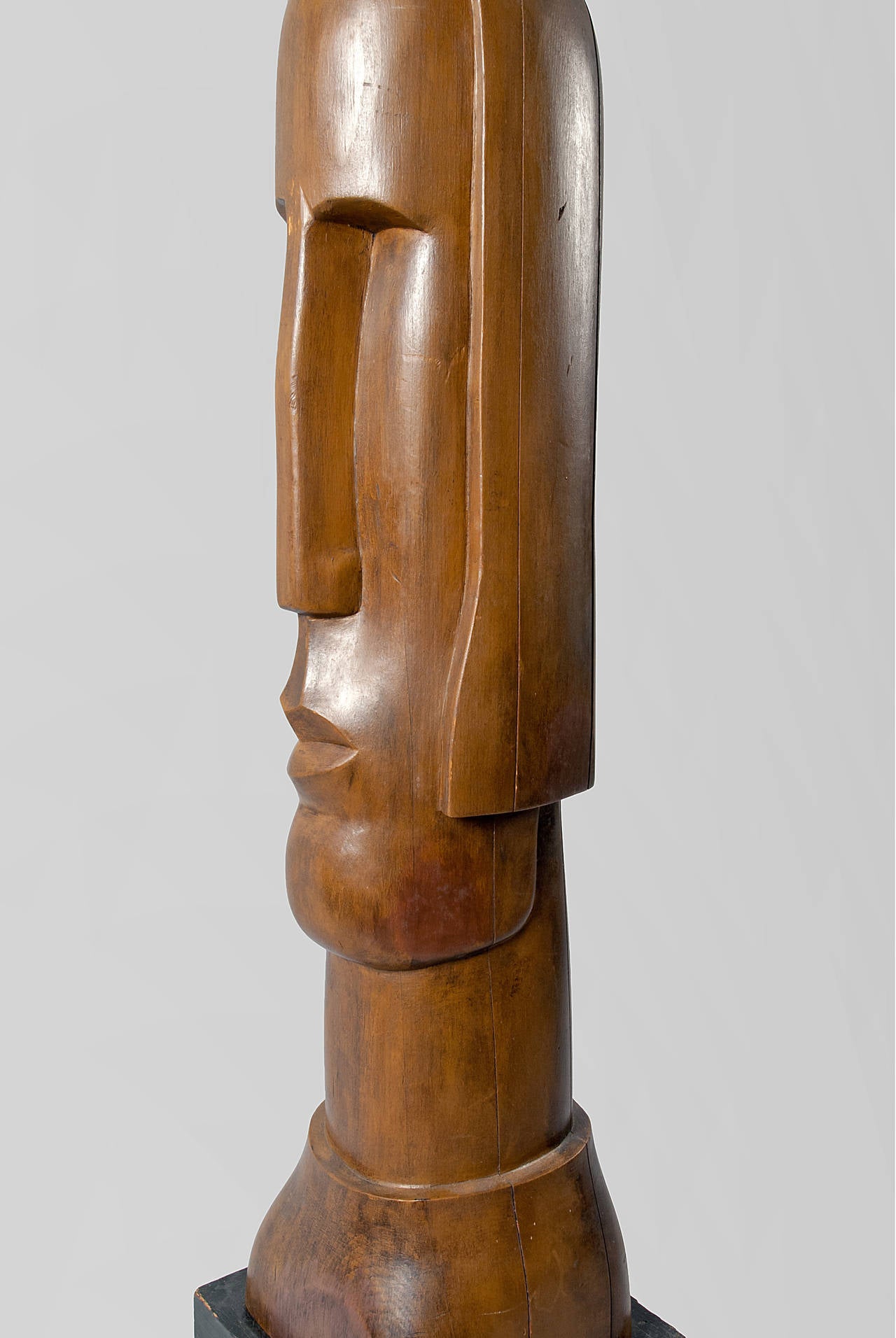 Wood sculpture of a “Female head with angular nose” by Nikita Karpenko (1898-1961).
The shoulder length bust depicts a female head with long beveled nose showing a quizzical expression. Pine finished with brown shoe polish.
31” high without