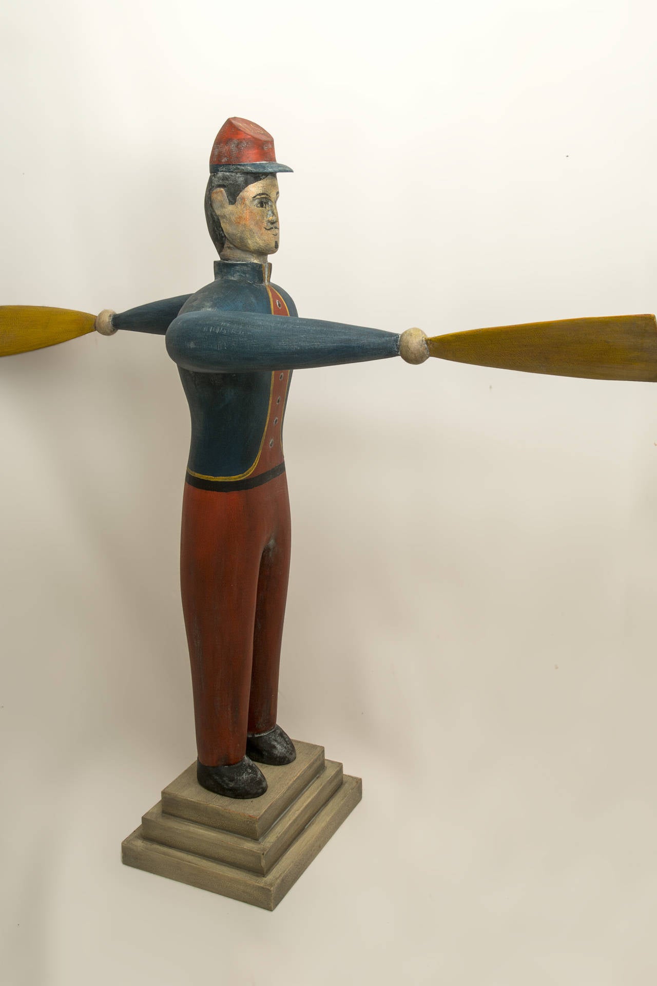 American soldier whirligig by K. William Kautz. Hand carved and painted with delicately muted primary colors, this whirligig is a contemporary interpretation of a combination of antique examples. With clean, sinuous lines, this sizable carving (46