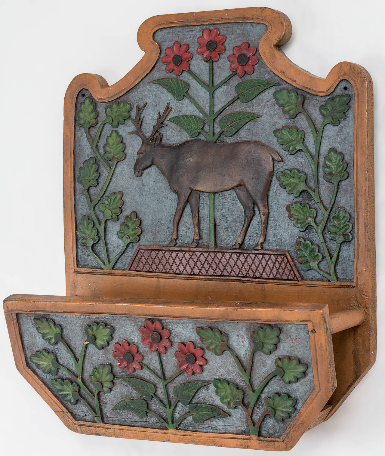 Moose relief carved wall pocket with original paint and shaped backboard
with floral design and blue ground color. Great piece of American Folk Art in untouched original
condition. Found in Maine,
New England, circa 1930-1940.