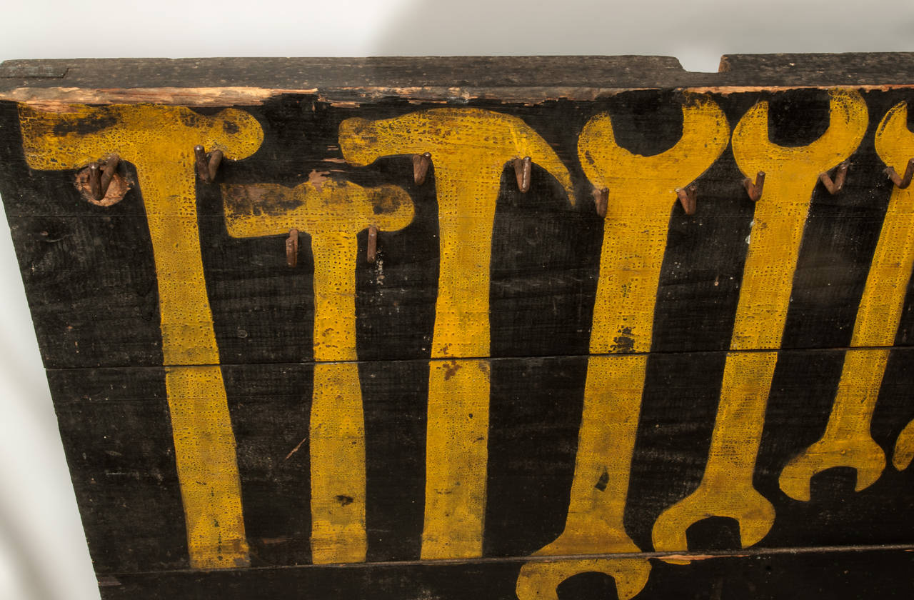 Painted tool board with original hooks and original black and yellow paint.
Wonderful original surface.