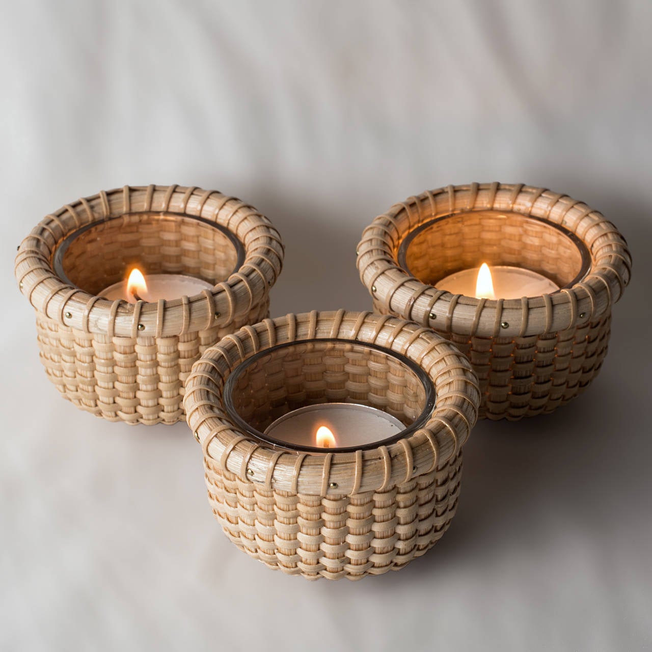Nantucket Basket Tea Lights by Nick Blazensky with removable glass insert and sized perfectly for a small disposable tea light.

Diameter 3 inches, Height 1.75 inches