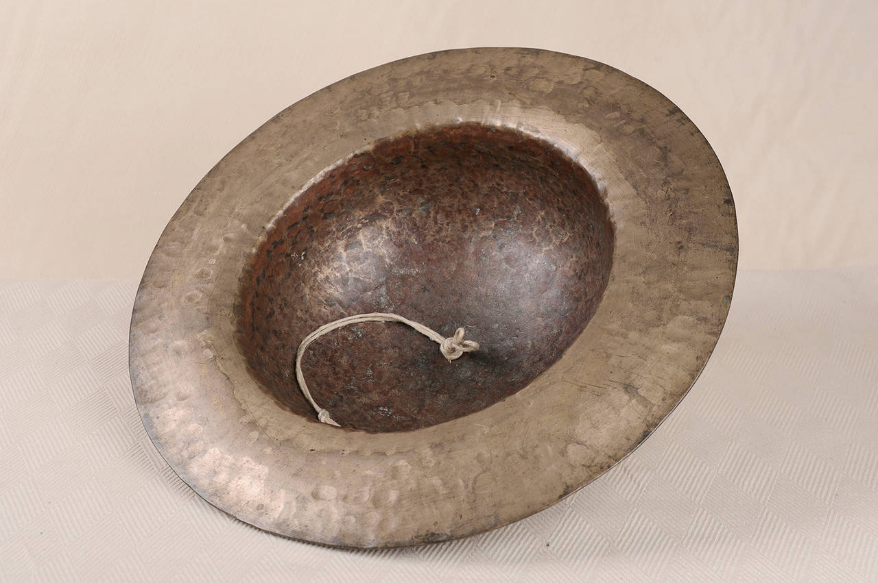 Part of an antique Bronze bell or Cymbal, hand hammered - Tibet - half XIX century - can be hung from the ceiling.
CYMBAL is a percussion instrument. Now it is used in many ensembles ranging from the orchestra, percussion ensembles, jazz bands,