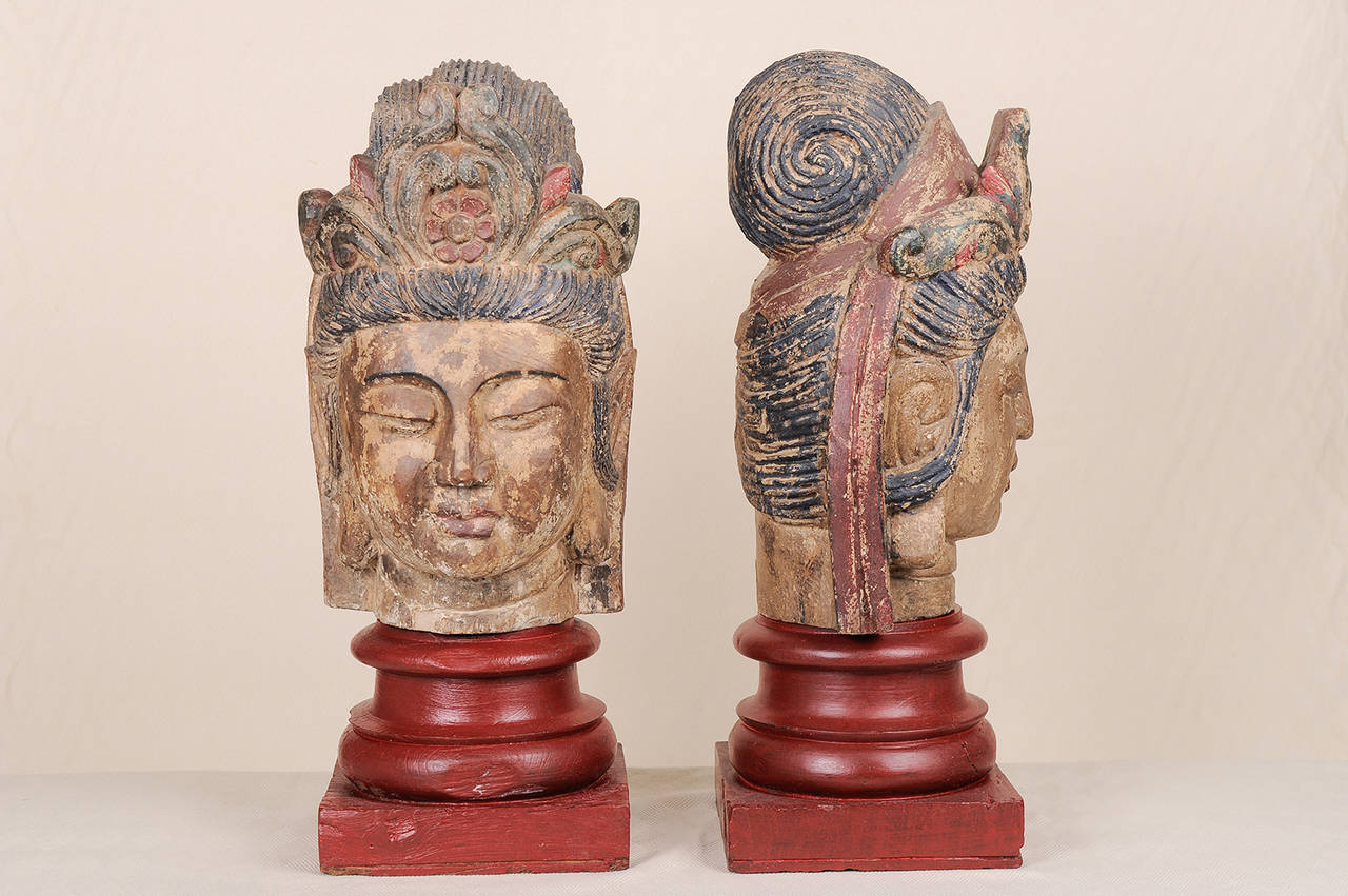 Seltenes Paar von  Buddha-Holzköpfe, mit polychromen Spuren - lächelnd und friedlich -
Auf einem Paar hölzerner Kapitelle aus der gleichen Epoche ruhend. SET. Geeignet für den Eingang eines Wohnzimmers oder für die Säulen am Fuß einer Treppe.
Es ist