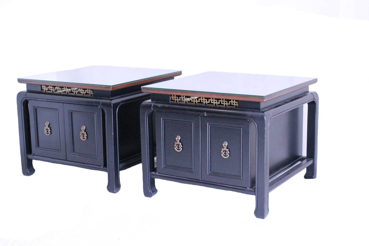 Mid-century black painted bedside tables with brass Chinois pulls and accent on apron.