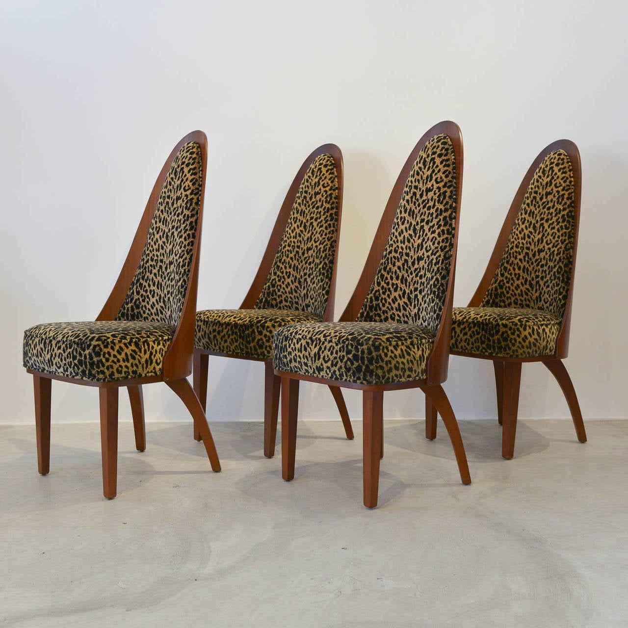 A beautiful and rare set of four atomic dining chairs by Chet Beardsley. Professionally restored wood is in perfect showroom condition. Original leopard velvet fabric is original to the chairs, and the fabric and foam are excellent.

Highly