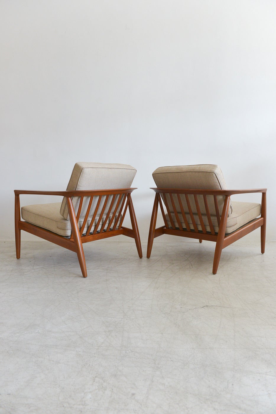 A beautiful and very rare set of Folke Ohlsson teak lounge chairs by renowned Swedish designer Folke Ohlsson for Dux of Sweden.

Rare, beautiful rounded and slatted curved back chairs with beautiful solid teak wood. The wood has been