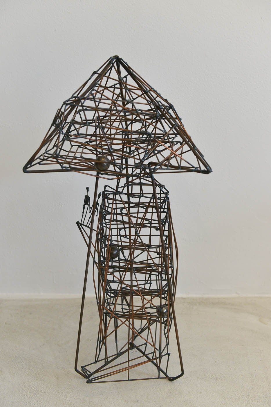 Rare kinetic wire sculpture by artist Guy Pullen. Three marble balls enter at the top of the sculpture and make their way down to the bottom of the tower. Original one of a kind piece, this is a great conversation piece for your home. Accented by