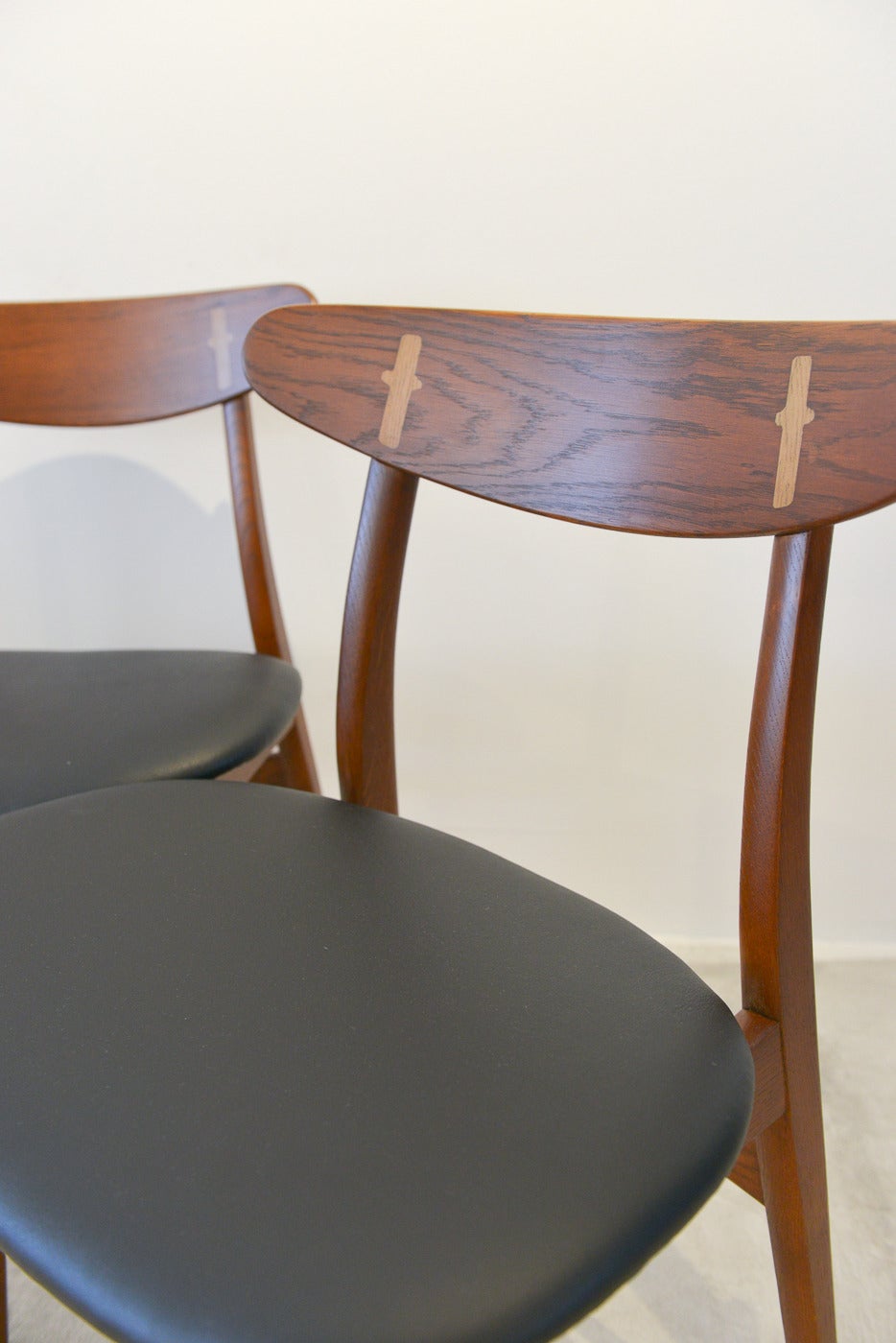 This beautiful pair of original Hans Wegner model CH-30 for Carl Hansen dining chairs has been professionally restored with beautiful black vinyl seats. Still retains the original labels on the underside, dated March 16, 1955.

Perfect vintage