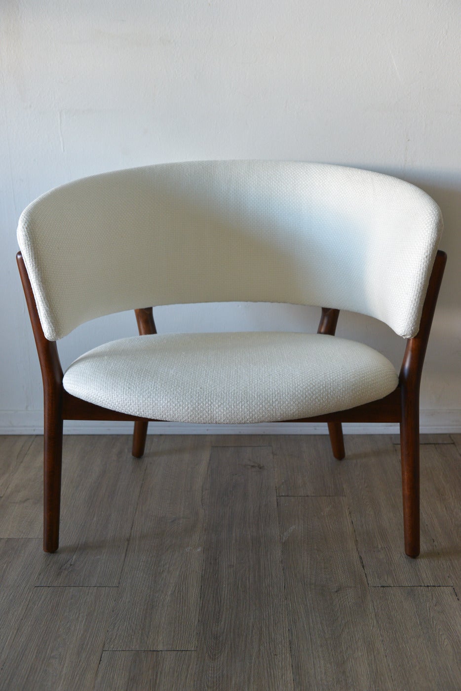 A stunning example of one of the most beautiful chairs ever designed by renowned Danish furniture and jewelry designer, Nanna Ditzel. Known for her beautiful curved forms and gentle lines, this chair is one of the most iconic and highly desirable