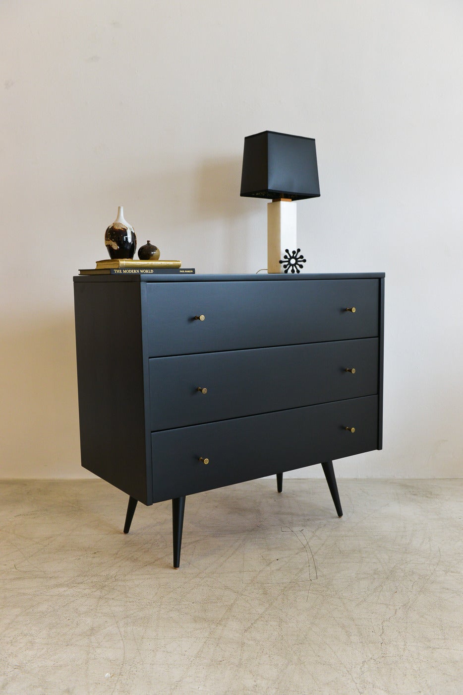 Vintage Paul McCobb Planner Group dresser for Winchendon. Professionally restored and ebonized black, this beautiful piece has the original brass hardware pulls with just the right amount of patina. Brass patina has been purposely left on the
