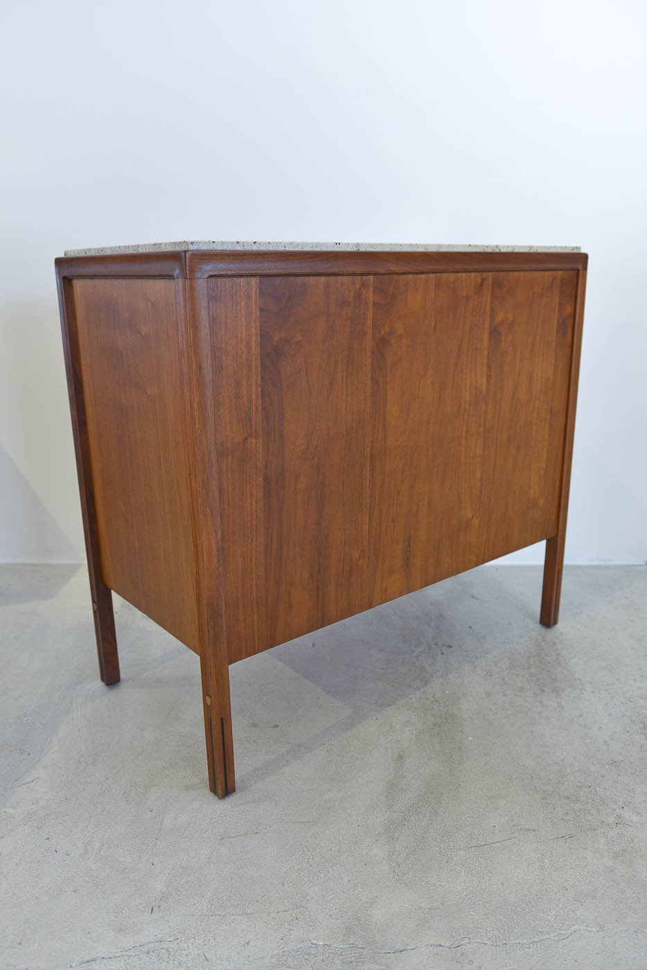 Walnut and cane cabinet with beautiful italian travertine marble top by Gerry Zanck for Gregori has been professionally restored in showroom perfect condition. The cane front has beautiful brass accents as well as the legs. Cane is perfect with no