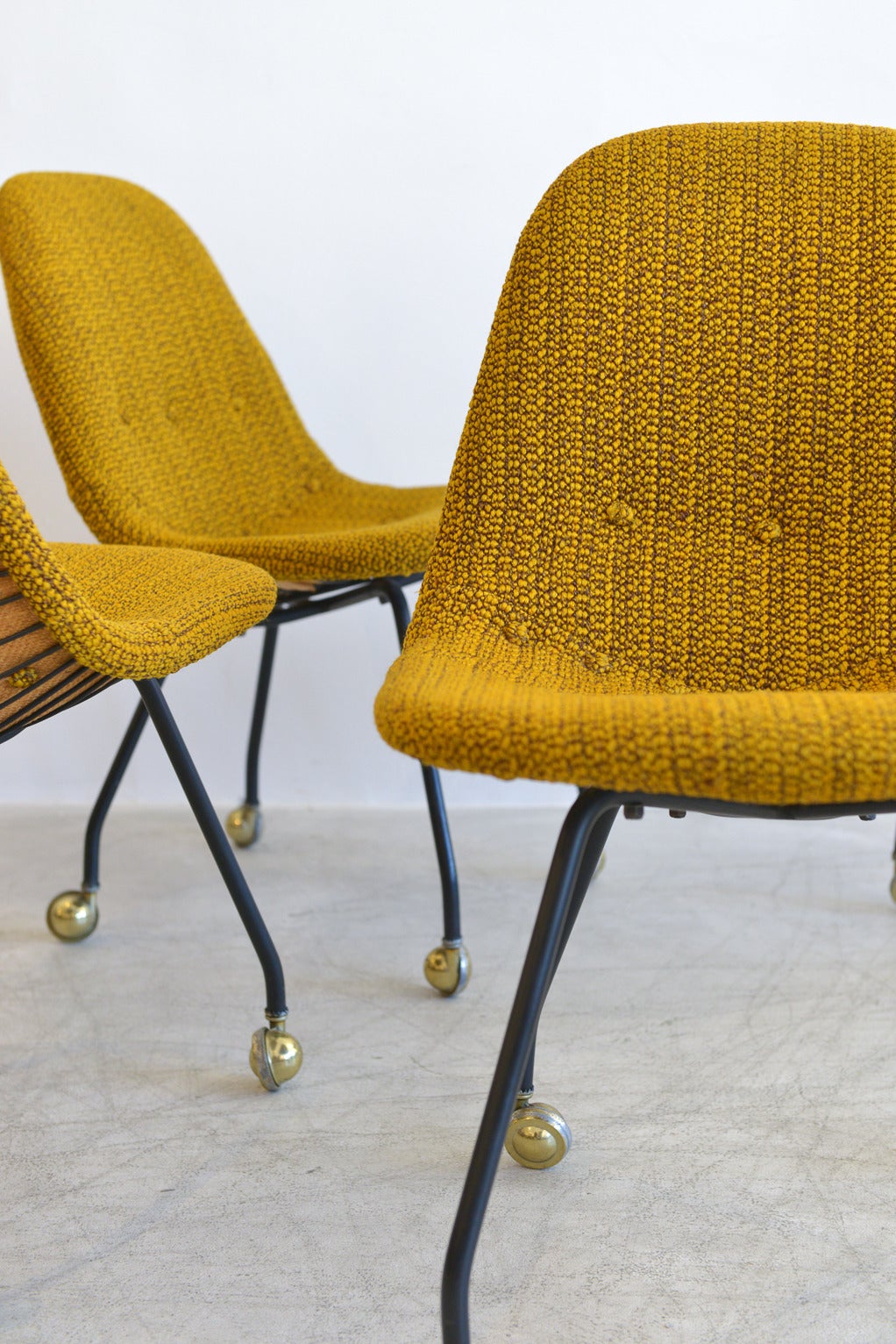 Very early and rare set of four wire mesh chairs by Charles Eames for Herman Miller. All chairs still have the original early Venice CA tags as well as the original form fitted seat covers with vintage Alexander Girard fabric in excellent vintage