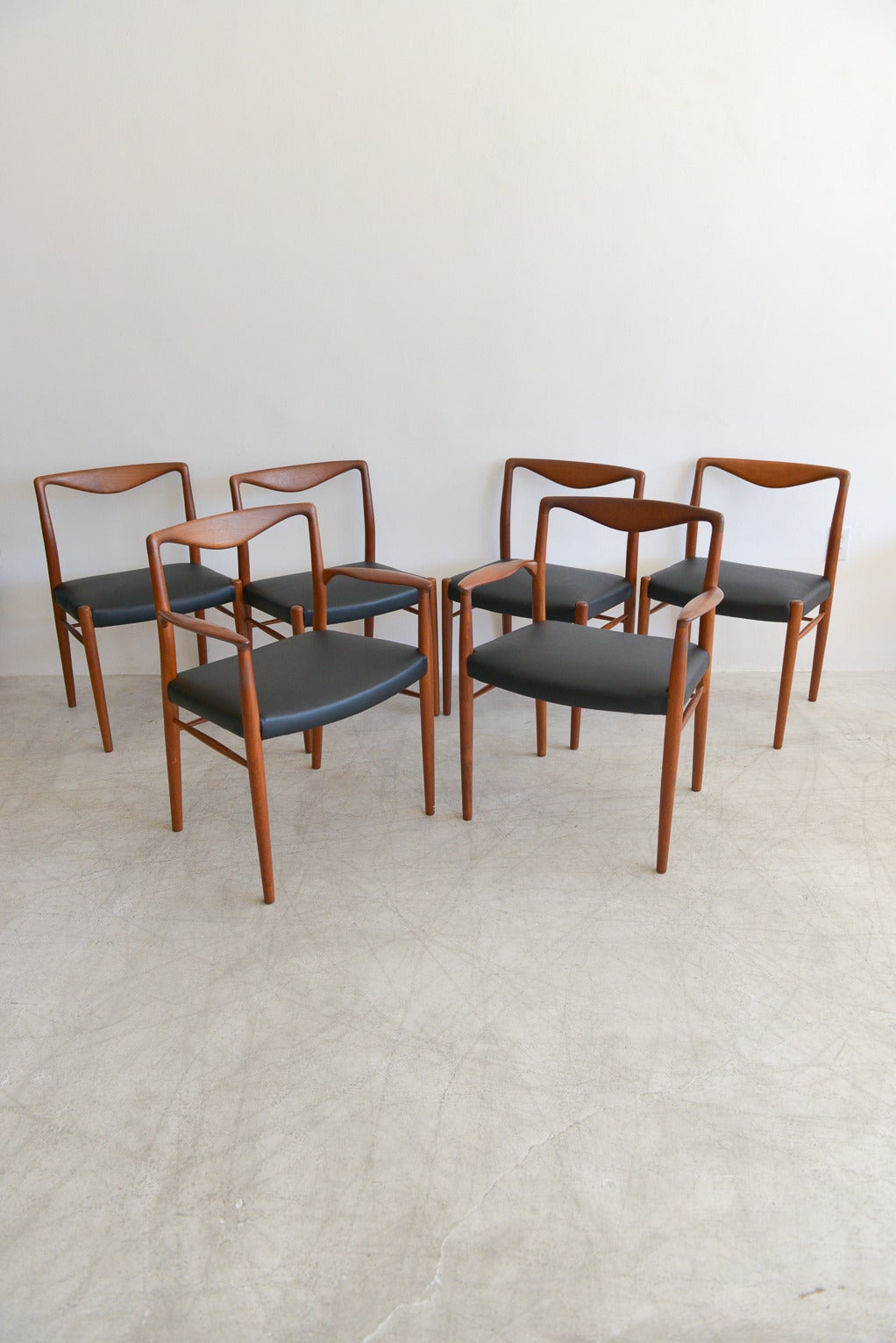 Made of solid sculpted teak, these beautifully sculpted chairs are artfully sculpted with delicate curves and backrests.

Designed by Kai Lyngfeldt Larsen for Søren Willadsen in the 1960s. Excellent vintage condition, newly recovered with black