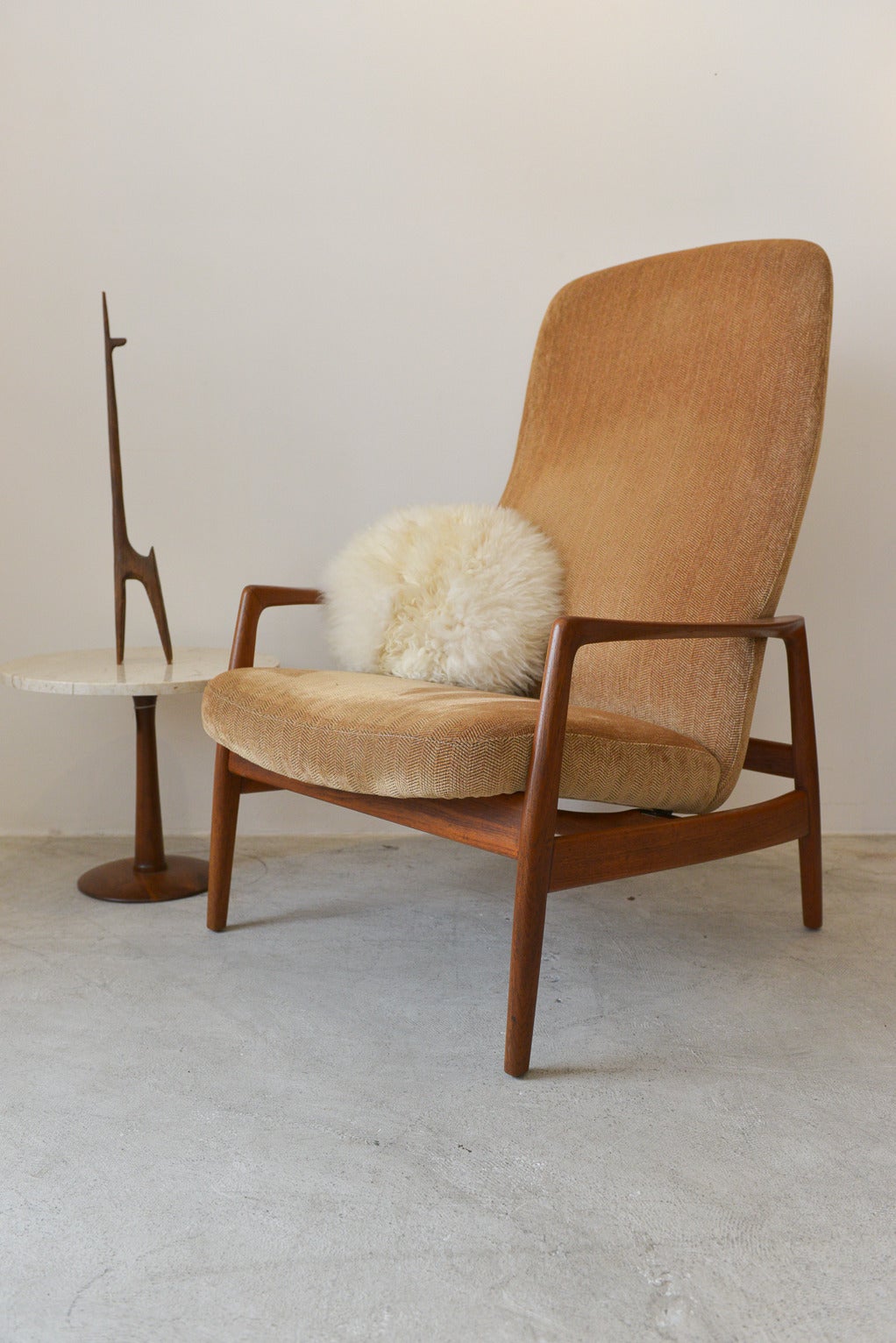 Beautiful teak lounge chair by Dux of Sweden. Teak has been refinished and is in showroom condition and chair has had the old foam replaced under the existing beige or tan fabric. Extremely comfortable, chair does not recline, is in a fixed position