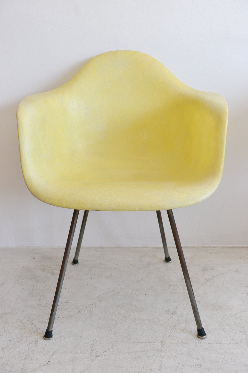 Beautiful early Charles Eames for Herman Miller Rope Edge armchair with fiberglass shell by Zenith Plastics.  Early production model, beautiful zinc x-base with rope edge in lemon yellow.  Original large shock mounts.  This chair is in excellent