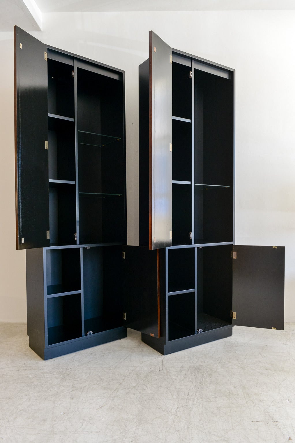 Pair of Harvey Probber ebonized display cabinets with rosewood doors, original glass shelving. Professionally restored to near perfect condition, these beautiful cabinets also have a fitting on top if you want to add a light for added