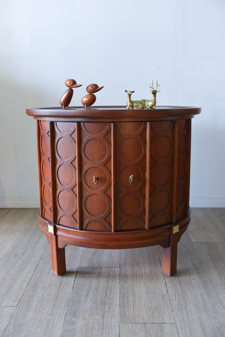 The most beautiful little drum circular side or end table, could also be used as a nightstand.  Wonderful hand carved circle patterns, star pattern on top with brass inlay.  Solid wood, heavy piece with two doors that swing open for added storage. 