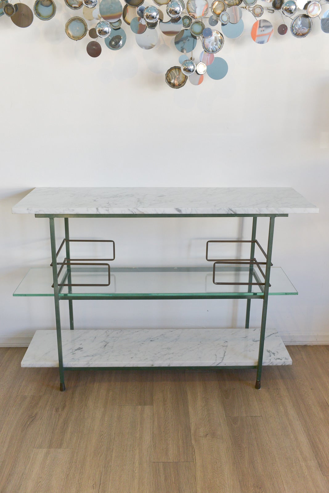 A beautiful and very rare bar or console by Italian manufacturer, Salterini. This beautiful bar has amazing design qualities and detail, with brass and iron frame and exceptional Italian white Carrara marble top and bottom shelves with a middle 1/4