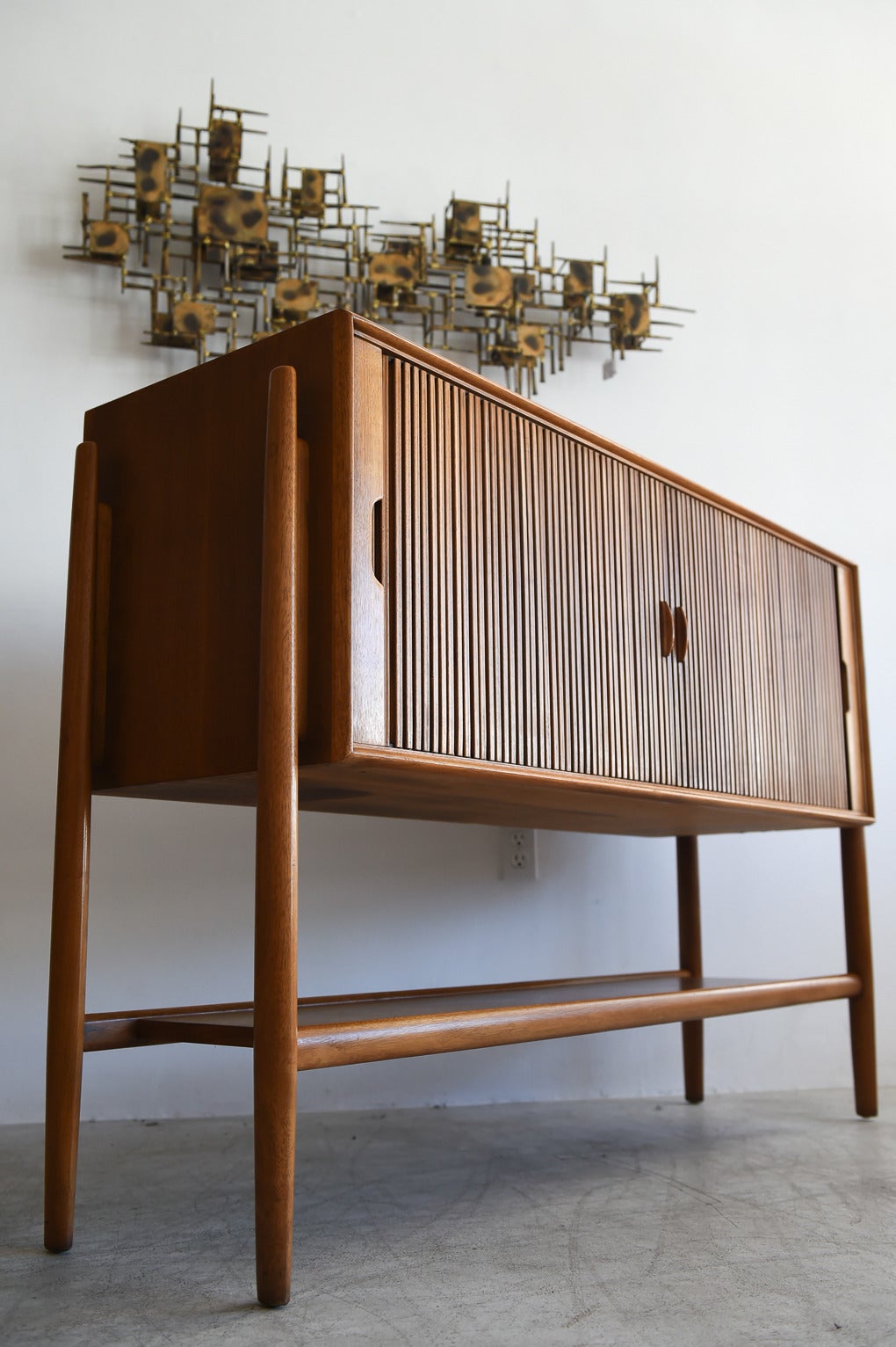 Impressive walnut tambour door walnut credenza designed by Barney Flagg for Drexel's Parallel line of furniture.

Beautiful original condition, hardly any wear at all. Sliding tambour doors slide smooth with no sticking and the credenza still