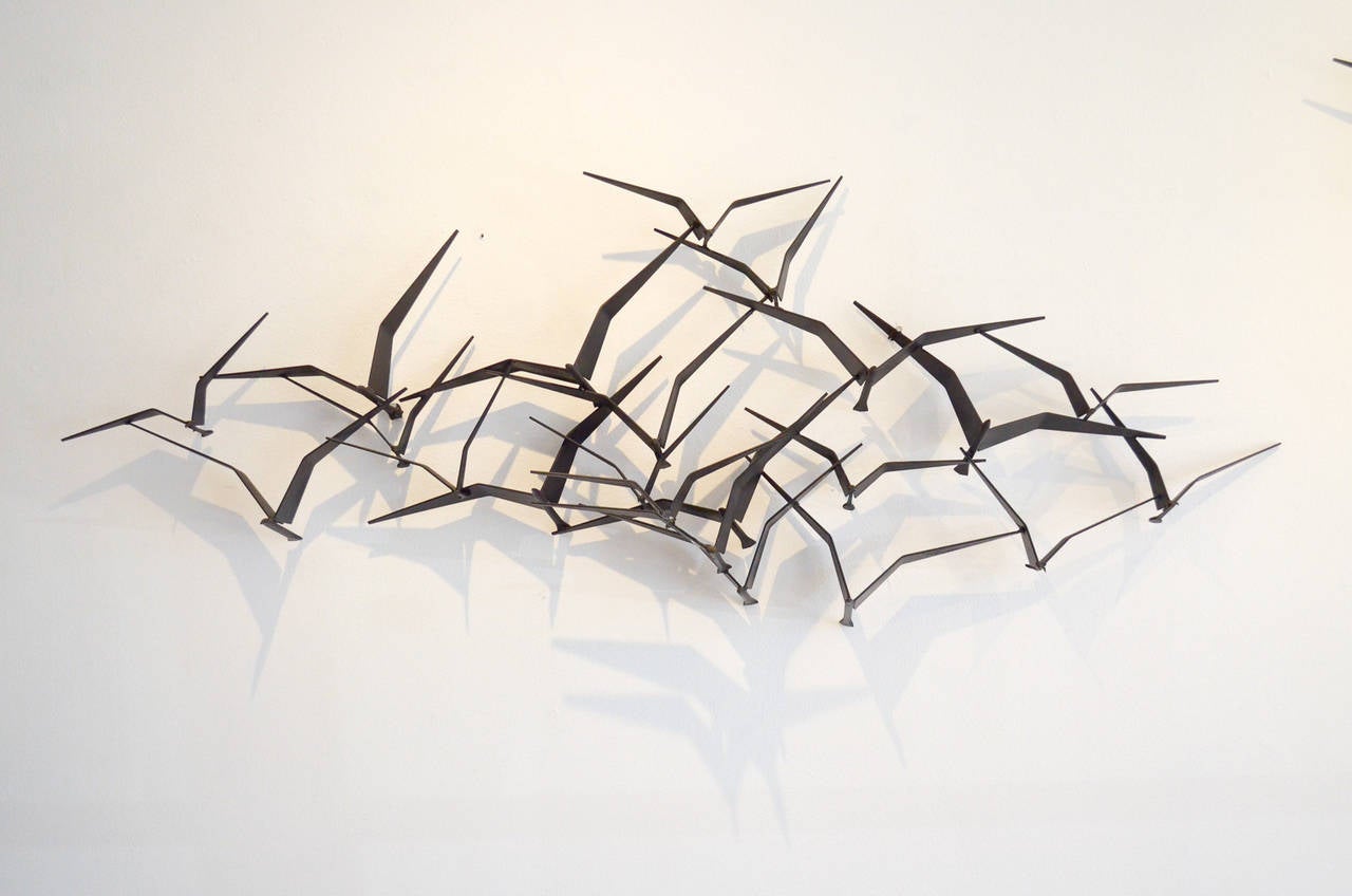 This is a beautiful and original C. Jere 'Birds in Flight' metal brutalist wall sculpture. Made of solid iron with sculpted birds, this piece is an iconic and Classic Mid-Century design. Incredibly popular and great looking in almost any wall, the