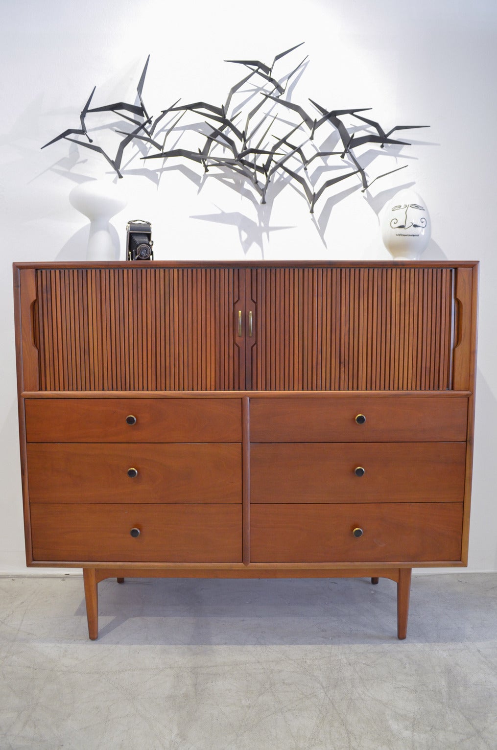 Beautiful walnut tambour door highboy or dresser by Kipp Stewart and Stuart McDougall for Drexel Declaration. Rare piece, not highly produced and scarcely available.

Beautiful walnut with upper tambour doors with drawers that are completely