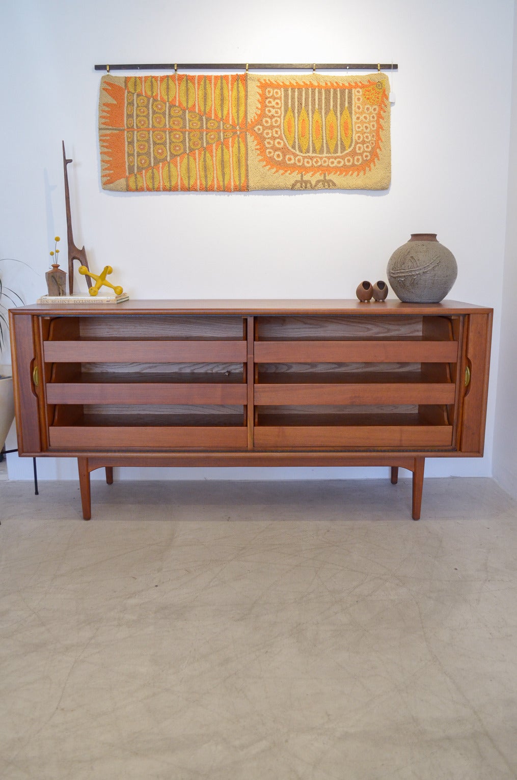 Stunning walnut tambour door credenza by Kipp Stewart for Drexel's Declaration line. Lovely lines, tambour doors glide smoothly and open to reveal shelving on the inside. Drawers roll smoothly and tambour doors are highlighted by beautiful brass