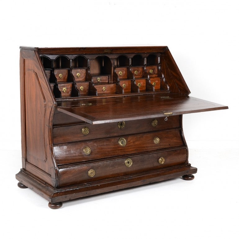 In heavy, solid mahogany and outfitted with several pigeon hole drawers, bombe silhouette on bun feet. This is rare and a wonderful piece, original condition, Circa 1820.