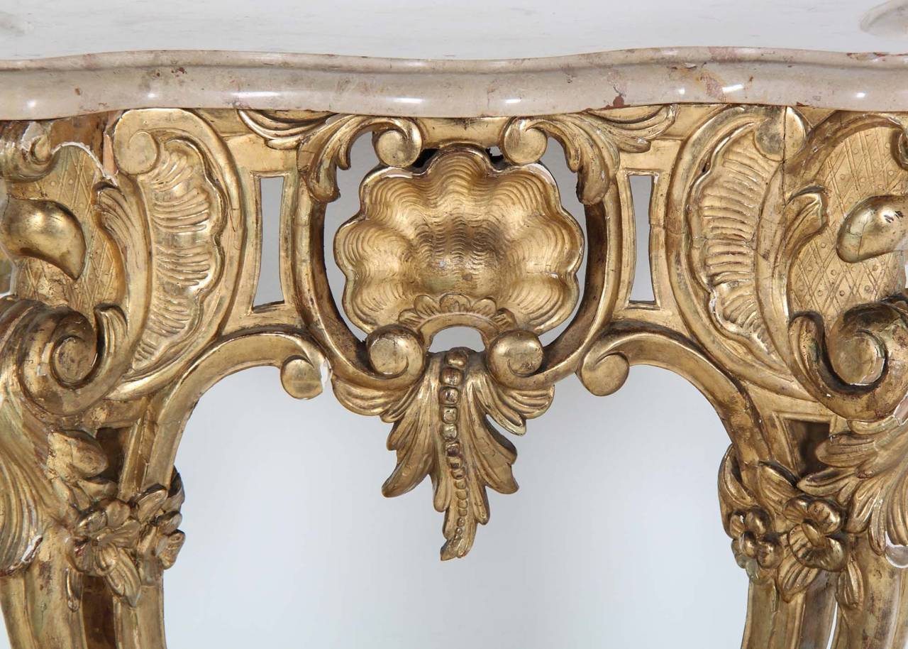 Antique 19th Century French giltwood console with marble top. Unusual diminutive scale in the width, but with an extended depth not typical in similar consoles. A superior quality piece in unrestored original condition with normal imperfections